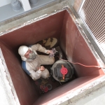 Sean scraping and sanding the tunnel between the Test Module and lung at SAM, Biosphere 2