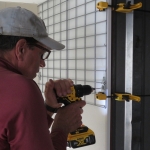 John Z. mounting grid wall to the crew quarters to workshop bridge at SAM, Biosphere 2