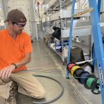 Matthias Beach pulling wire for the fire detection system at SAM, Biosphere 2