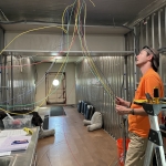 Matthias Beach pulling wire for the fire detection system at SAM, Biosphere 2
