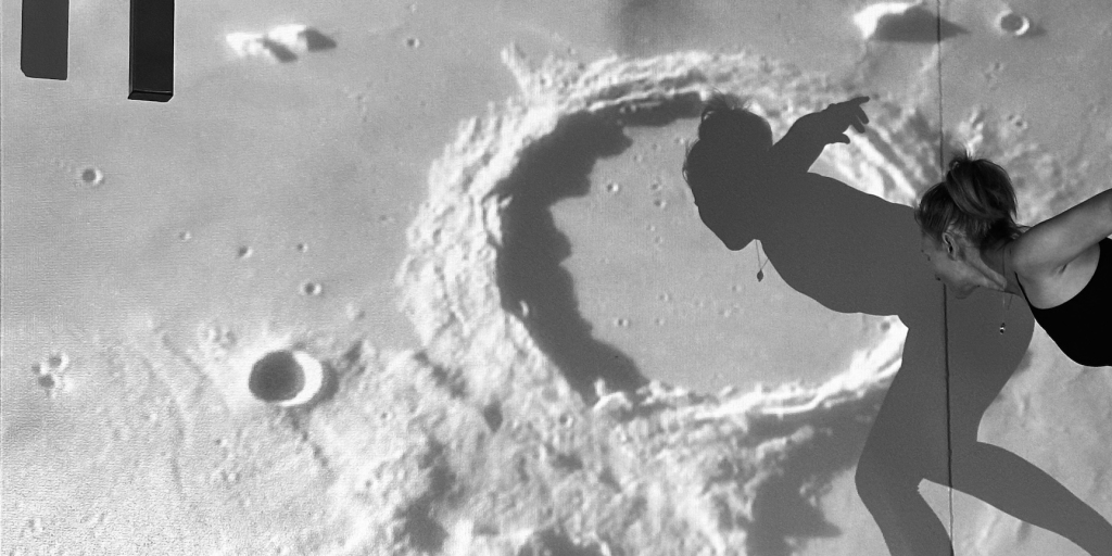 Elizabeth George in the SAM lung with lunar image