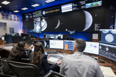 jsc2026e020490 (April 6, 2026) - Pictured from left to right, Angela Garcia, Dr. Kelsey Young, and Dr. Trevor Graff, the first science officers of the Artemis program in the White Flight Control Room in the Christopher C. Kraft Jr. Mission Control Center at NASA’s Johnson Space Center. Seen here about ten minutes before Earthset during Artemis II, these science officers are seen monitoring mission data in real-time from the Science console. They support flight controllers by analyzing scientific measurements and system performance. Their work helps ensure mission objectives are achieved safely and efficiently. Credit: NASA